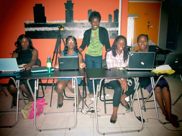 Joy teaches students to code in a Zambian classroom.