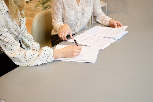 Two women working together at table