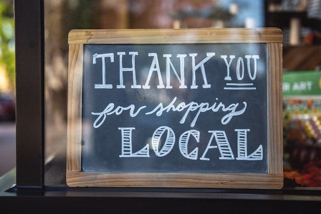 Chalkboard sign that says thank you for shopping local