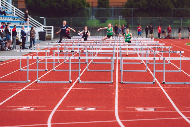 Racers running hurdles