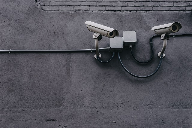 Security cameras on a grey concrete wall