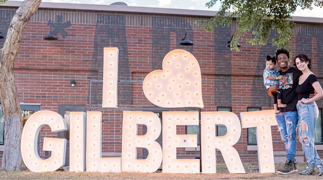 Family standing in front of I Love Gilbert sign