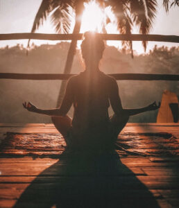 Woman meditating in tropical environment