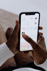 selecting TikTok app on smartphone