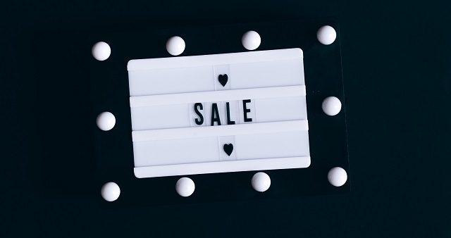 Black and white letterboard with the word “Sale”