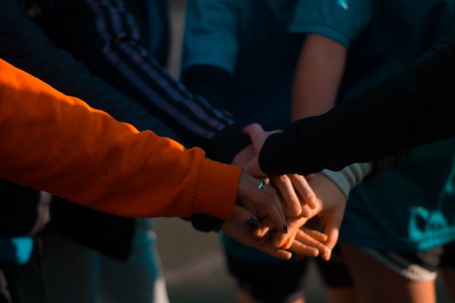 Group of people with hands stacked