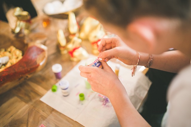 Person making beaded art