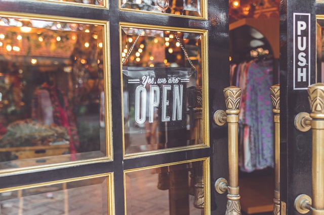 Storefront with an open sign and door ajar