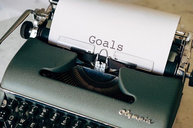 The word ‘goals’ on a piece of paper in a typewriter