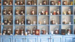Apothecary jars on a blue set of shelves