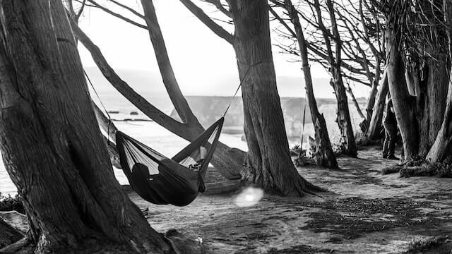 person in hammock on beach