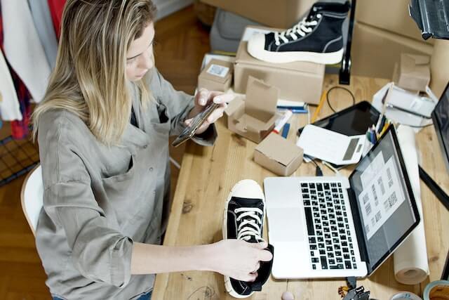 Woman taking photos of shoes to sell online-2