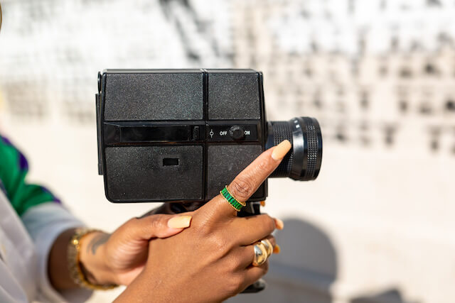 woman holding vintage video camera