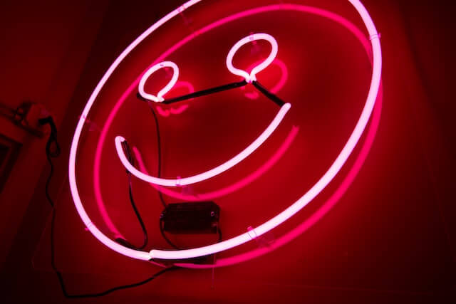 Pink neon light in shape of a happy face-2