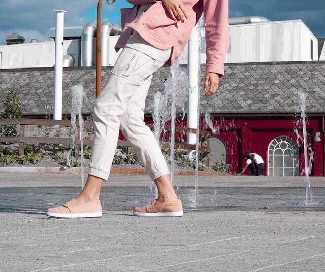 Woman modeling off-white cargo pants in outdoor setting