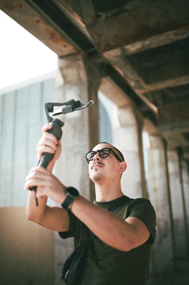 Man holding a selfie stick with a mobile phone attached