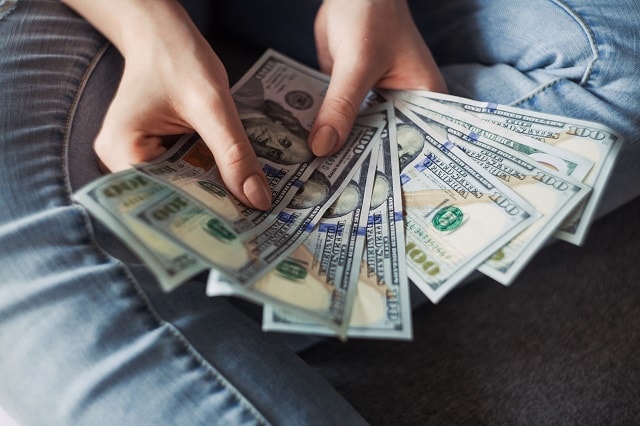 Woman Seated Counting Money