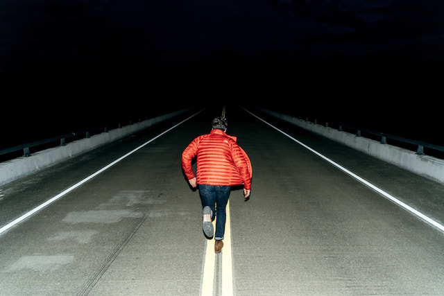 Man running down road a night