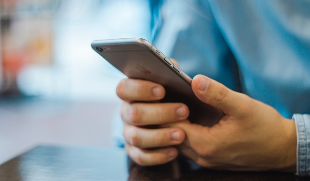 Man Holding Viewing Mobile Phone