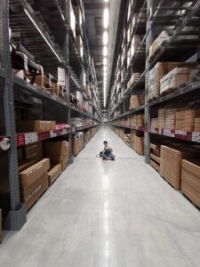 Person Sitting On Floor Of Warehouse