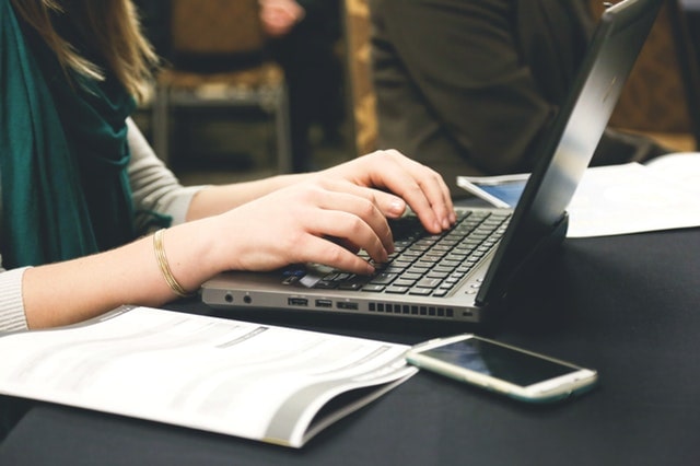 Website Launch Checklist Woman Typing On Laptop