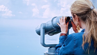 Woman Looking Through Binoculars Represents Scoping Out Competition