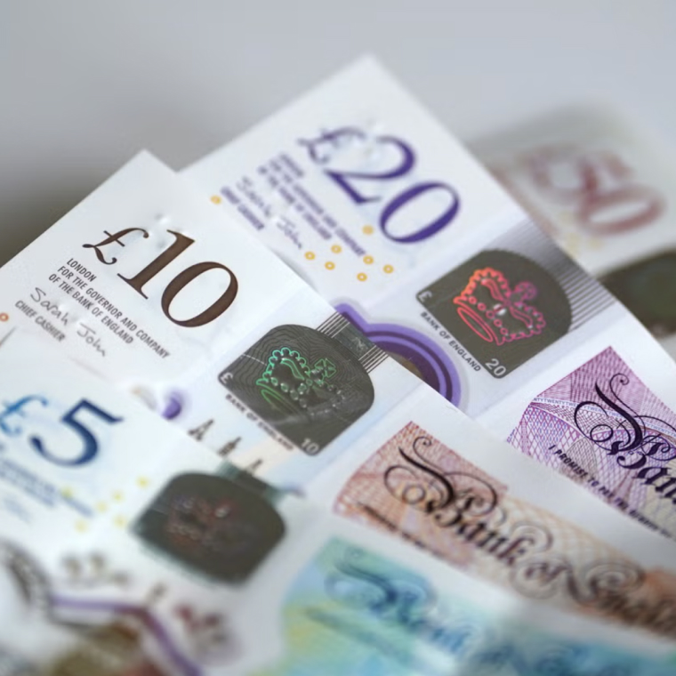 Close-up of British pound banknotes in £5, £10, £20, and £50