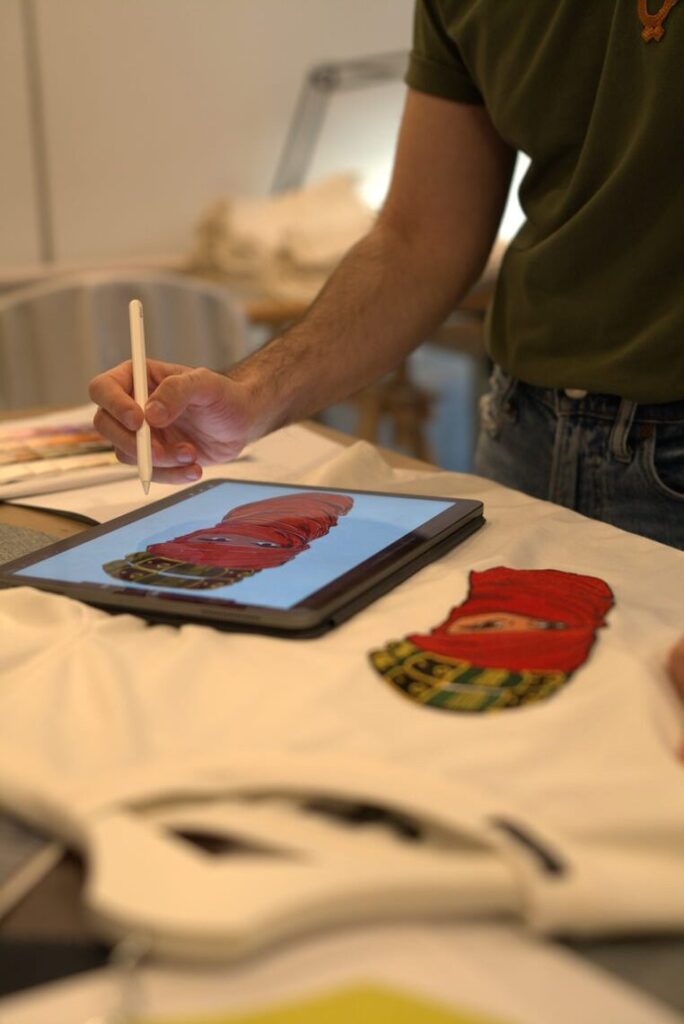 Zaid Farouki, fashion designer creating a design on a tablet