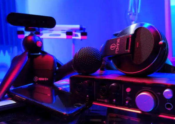 Pile of audio equipment in a room lit by blue LED lights
