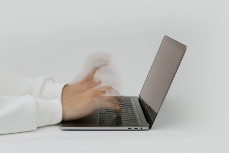 Hands Typing An Email On A Laptop