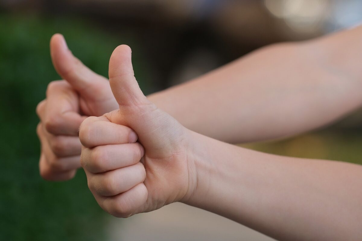 Two Hands Showing A Thumbs Up