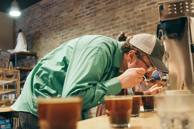 Man Sampling Different Cups of Coffee