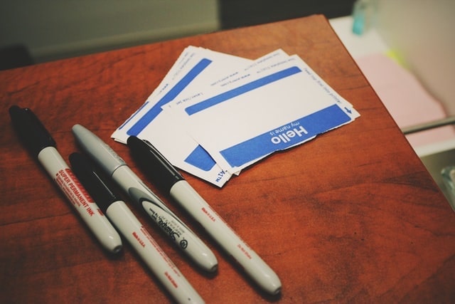 Blank Nametags Sitting on a Table with Markers