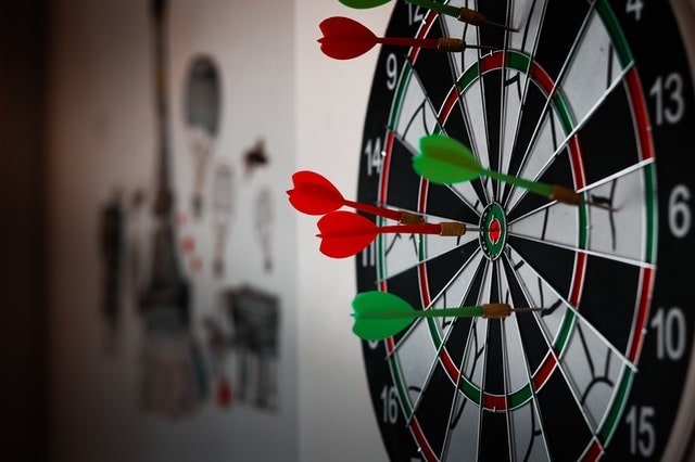 Close-up of dart pins in dart board