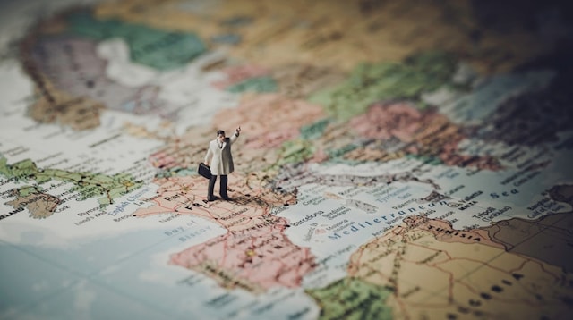 Market Segmentation Doll Standing on Map