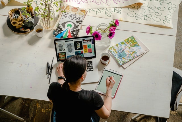 Overhead view of a graphic designer working at a table