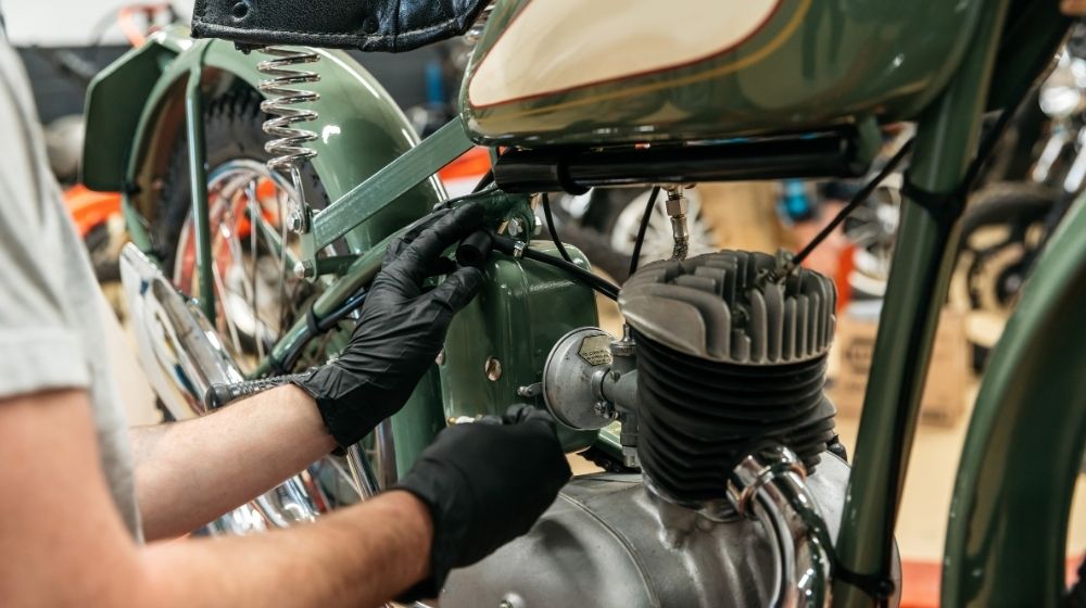 Person repairing a motorbike