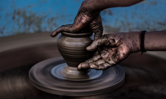 Person Throwing a Pot on a Potter’s Wheel