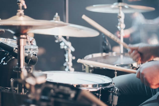 Closeup of a person using a drum set