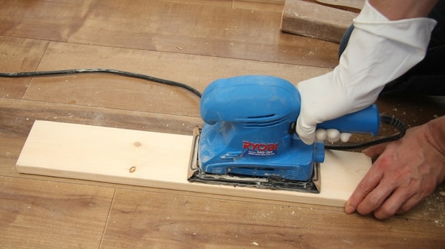 Carpentry Apprenticeship Sanding a Board