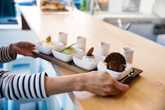 Food server holding a tray of ice cream