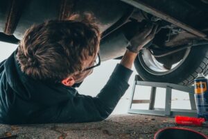 Man working underneath a car