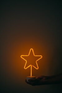 Person holding a neon star light