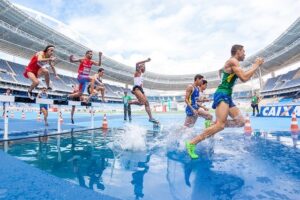 Runners jumping hurdles