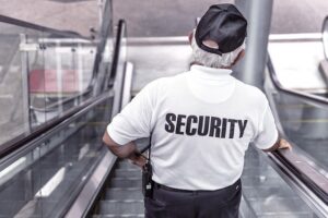 Security officer riding an escalator