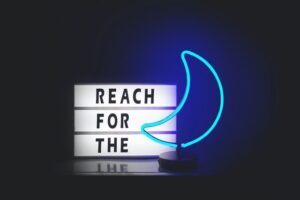 sign reading reach for the moon