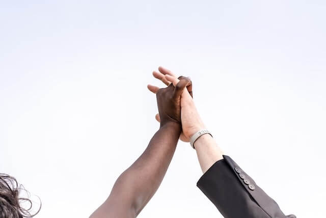 Two hands held high in victory