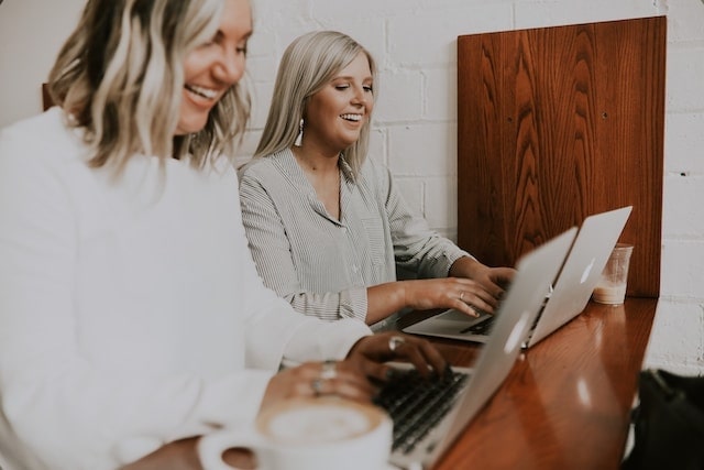 Two women working side by side