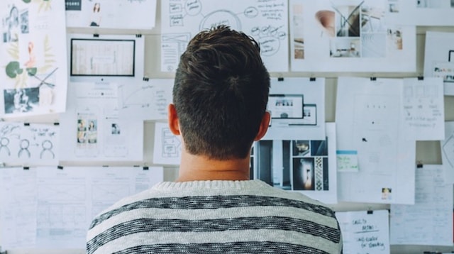 Website Design Man Looking at Idea Board