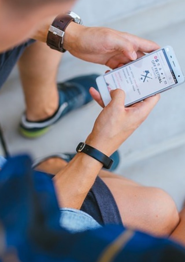 Man Using Smartphone to Look for Event